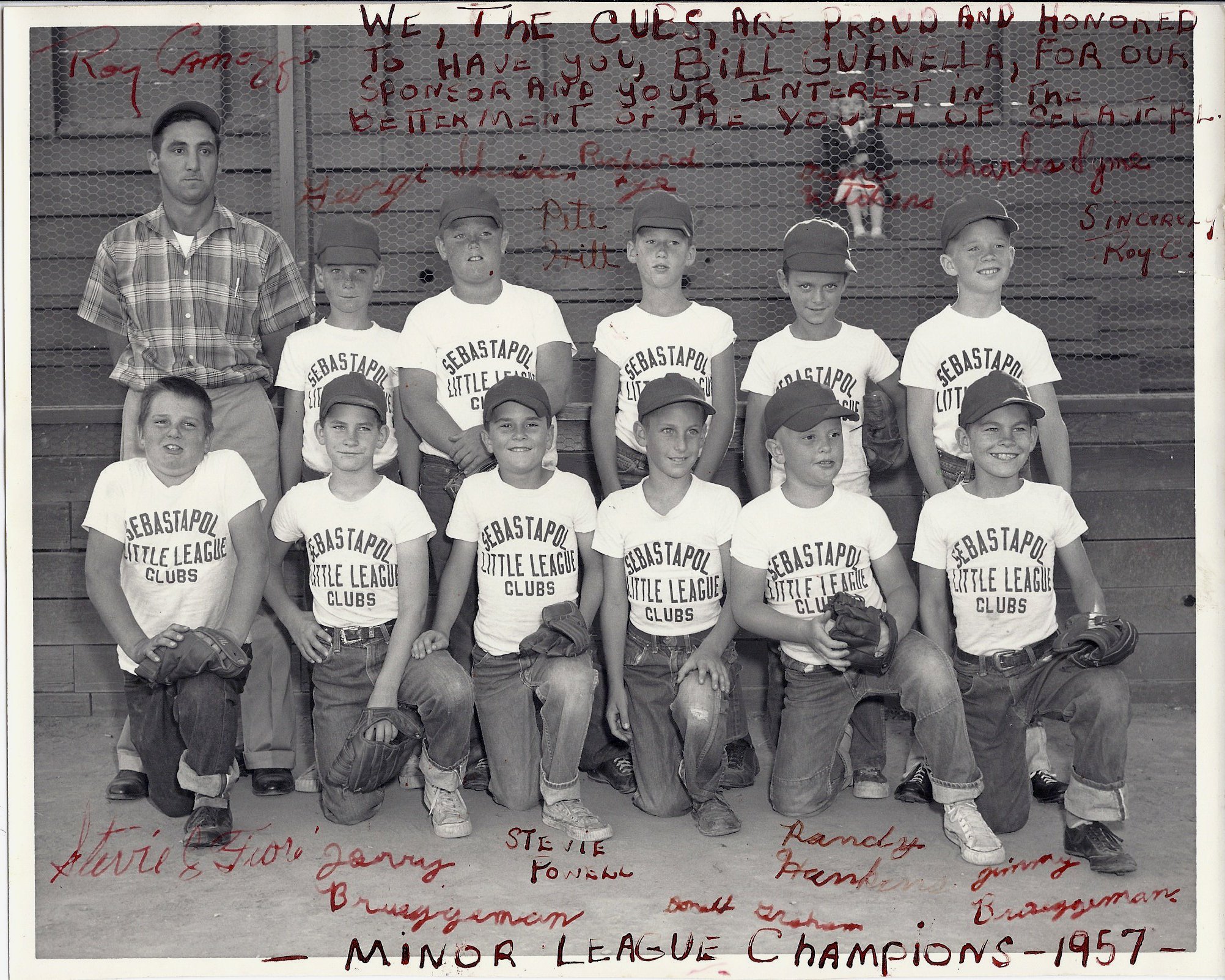 Minor League Baseball Champions 1957 team photo. 1957 was the first year of Little League in Sebastopol and was sponsored by Bill Guanelle. Photo was taken at Ives Park with the old wooden bleachers in the background and chicken wire backstop. All the players are wearing Sebastopol Little League Clubs t-shirts and caps. (Note the misspelling of “Sebastopol” on the t-shirts.) Hand written in red on the photo are all the signed names of the players and the following: “We, The Cubs, are proud and honored to have you, Bill Guanelle, for our sponsor and your interest in the betterment of the youth of Sebastopol.” Pictured are: back row L-R: Coach Roy Camozzi, George Sheridan, Pete Hill, Richard Fye, Duane Kitchens and Charles Symes. Front row: L-R Stevie Fiori, Jerry Breuggmann, Stevie Powell, Donald Graham, Randy Hankins and Jimmy Breuggmann.