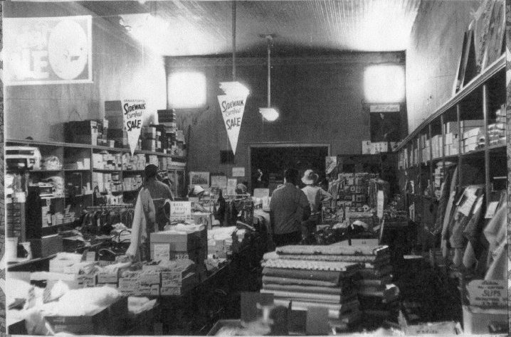 The interior of Wohler’s Dry Goods store, taken during a “Sidewalk Sale”, circ. 1965. Clothing, shoes, fabric flats, and shoppers are seen. Western Sonoma County Historical Society photo collection.